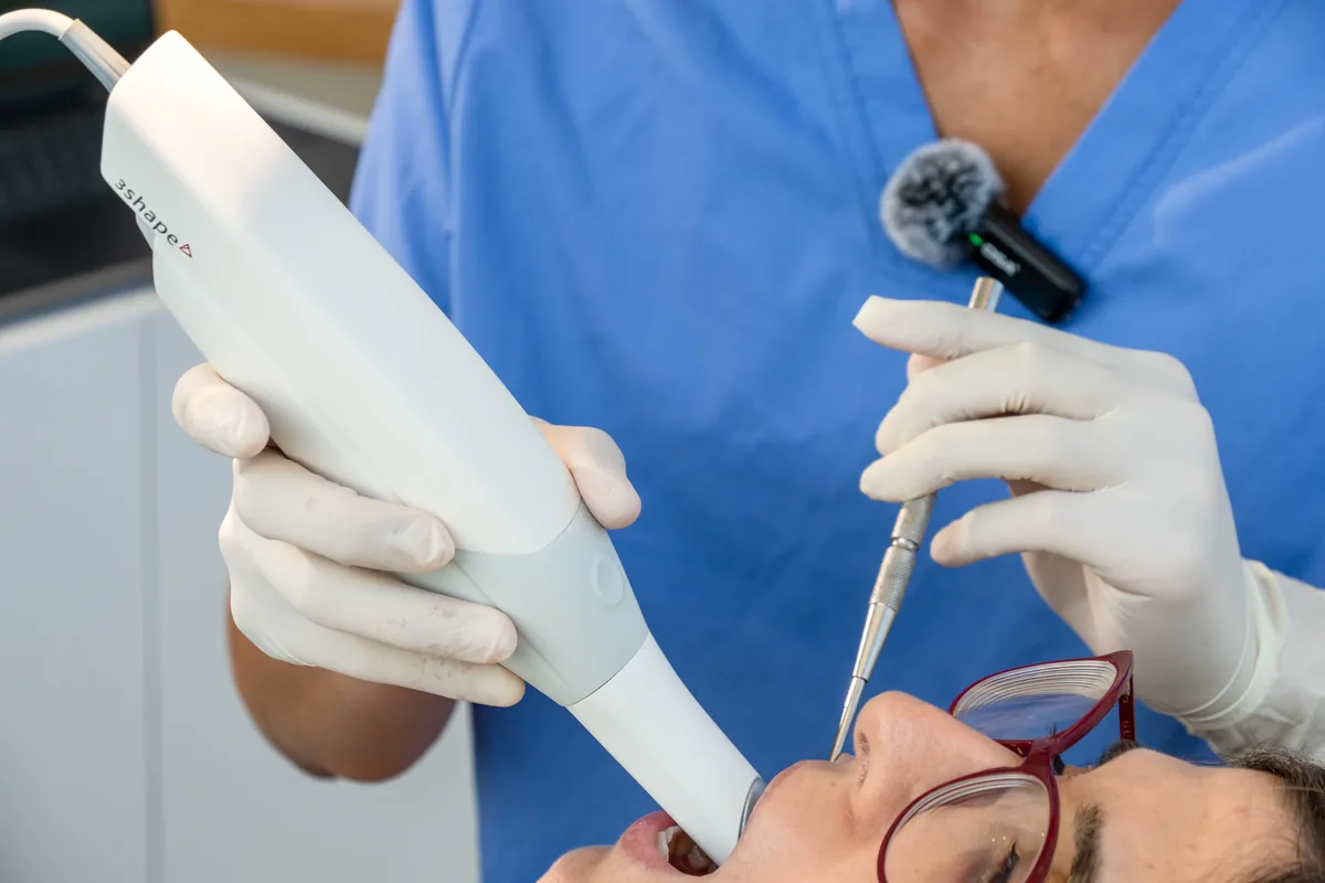 Dental shade guide held against a patient’s teeth at the practice